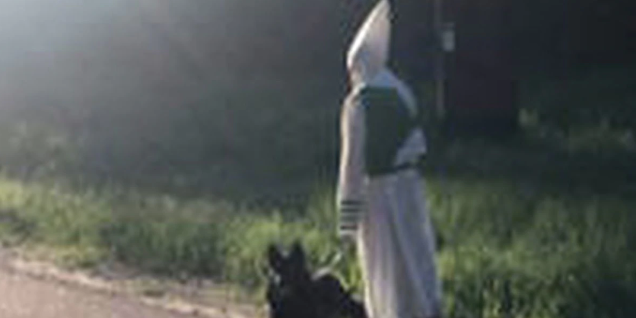 Man in KKK Outfit Spotted Walking Dog Waiving To Neighbors
