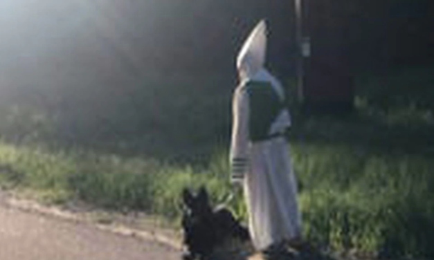Man in KKK Outfit Spotted Walking Dog Waiving To Neighbors